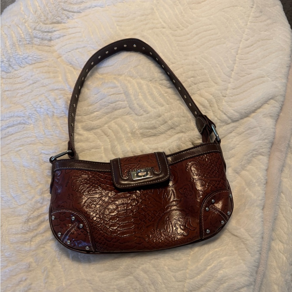 Brown leather and silver hardware M.C. Shoulder bag.